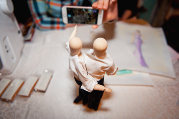 wooden figurine of a man in white shirt