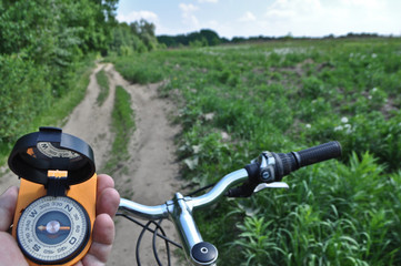 Fototapeta na wymiar journey by bike with a compass.