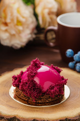 French pastry with pink glaze and burgundy sponge cake