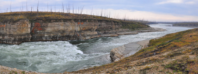 Panorama of rapid in a rocky canyon.