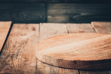 Toned photo. Color tone tuned. Wooden background with wooden table, tablecloth and round cutting board