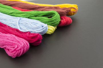 Threads for sewing on a black background
