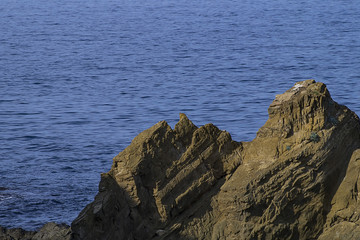 Rock on a background of blue sea