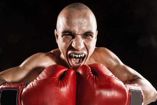 The Young Man Kickboxing On Black  With Kapa In Mouth