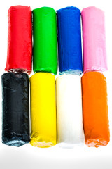 Цветной пластилин на белом фоне.