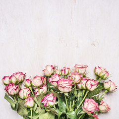 beautiful fresh spring shrub roses girl gift border ,place for text  on wooden rustic background top view