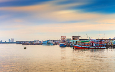 Fototapeta premium fisherman boat docking at pier in the sunset