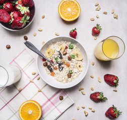 delicious breakfast with cereal, milk and strawberries on wooden rustic background top view close up