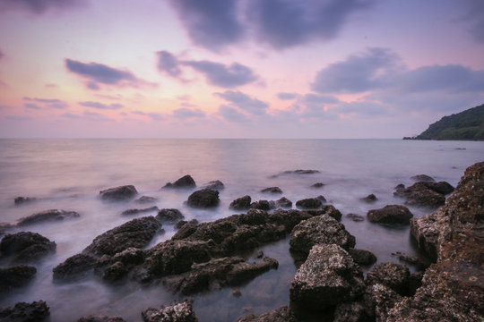 Coastal twilight scene, Long Exposure of rocks and waves at suns © juthamaso