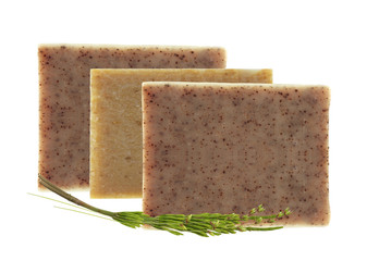 bars of natural soap with dried herbs isolated on white backgrou
