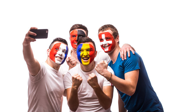 Group of football fans of their national team taking selfie photo on white background. European 2016 football fans concept.