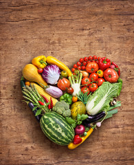 Heart symbol. Vegetables diet concept. Food photography of heart made from different vegetables on wooden table. High resolution product.