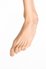 Pedicure and foot care topic: the naked man's legs isolated on white background in studio