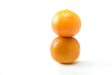 Two tangerine on top of each other isolated