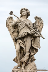 Fototapeta na wymiar Marble statue of Angel with the Sponge by .Antonio Giorgetti from the Sant'Angelo Bridge in Rome, Italy,