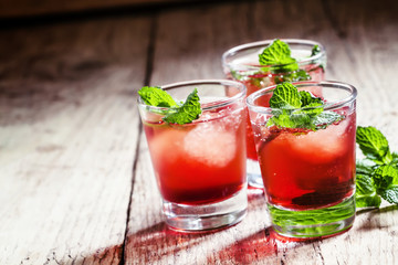 Cranberry cocktail Cape Codder with vodka and ice, selective foc