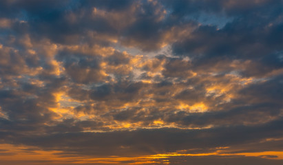 Naklejka na ściany i meble Dramatic sunset sky with clouds over sea