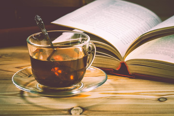 Cup of tea and books onwooden background 