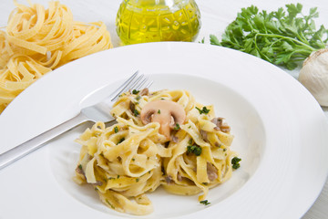 dish with tagliatelle and mushrooms and fresh ingredients