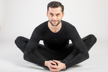 Young male performing yoga