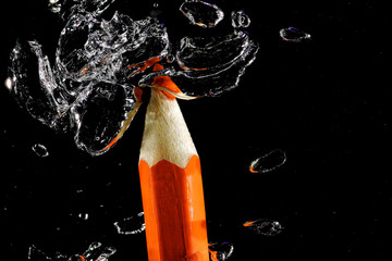 Crayon under water with bubbles of air.