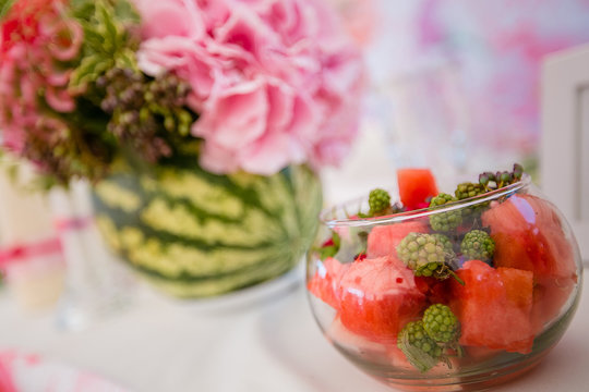 Still life with wild flowers bowl of watermelon.