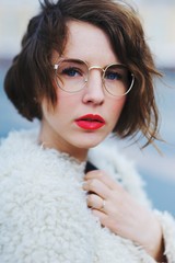 beautiful portrait of romantic a pensive girl in glasses