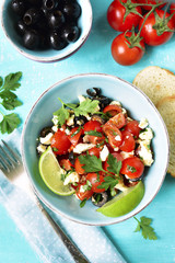 Tomato salad with feta cheese and olive.