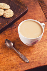 Cup of milk coffee with cookies for breakfast