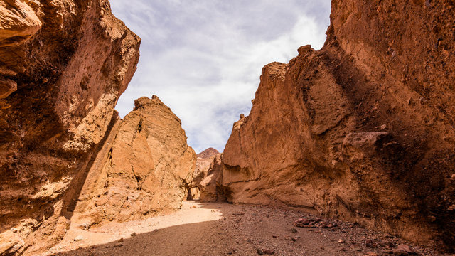 Narrow canyon with vertical walls on both sides. Sandstone formations in Natural bridge canyon trail, Death Valley