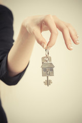 Female hand with a house key 