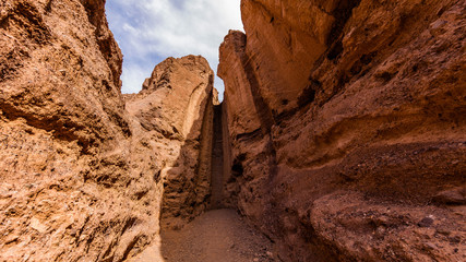 Dry waterfall. Narrow canyon with vertical walls on both sides. Sandstone formations in Natural bridge canyon trail, Death Valley