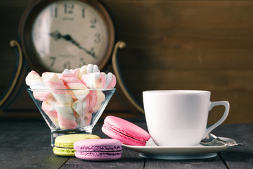 Colour french cookies on dark rustic wooden table