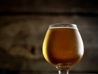 beer in a glass on a wooden background