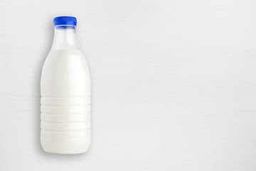 Milk bottle on white wooden table