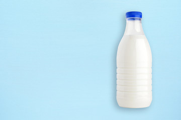 Milk bottle on blue wooden background