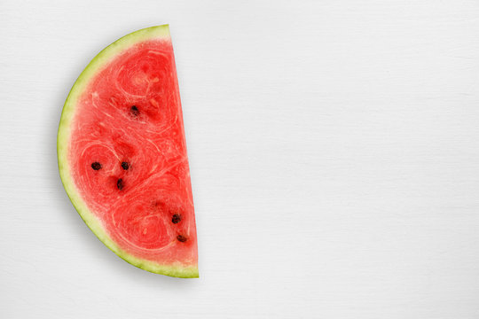 Watermelon slice on white table