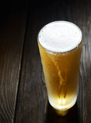 beer in a glass on a wooden background
