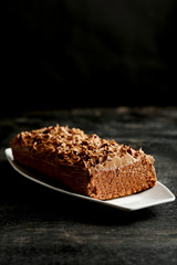 Chocolate cake on a black wooden background