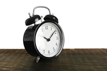 Alarm clock on wooden table.