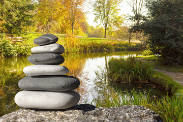 Close up of zen stones with background the garden and the lake