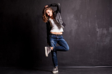 Fototapeta na wymiar model girl dancing on a black background