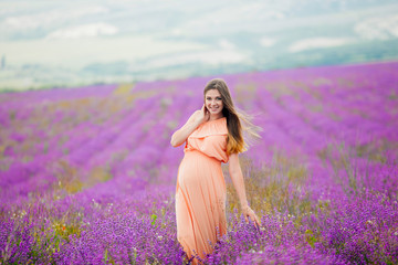 Fototapeta na wymiar pregnant girl goes in Lavender