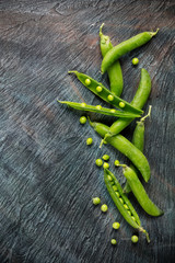 Green peas on black stone