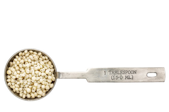 sorghum grain in a tablespoon