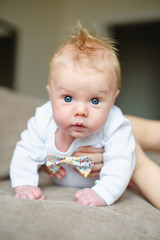 Fototapeta premium little baby boy lying on soft blanket in room