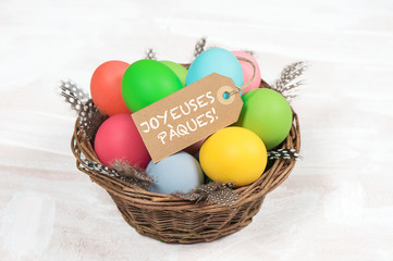 Easter eggs in basket with feather decoration