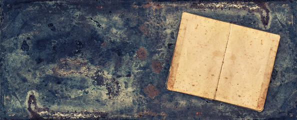 Antique book on rustic metal texture background
