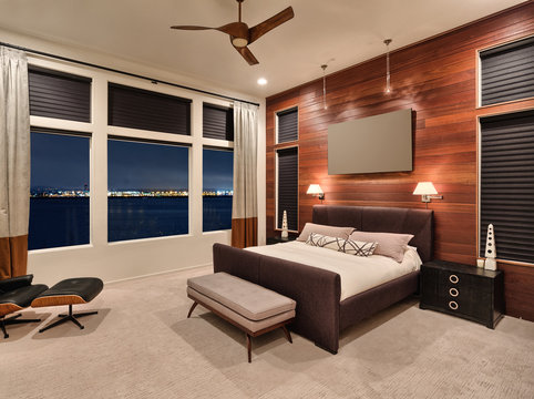 Master Bedroom At Night In New Luxury Home, With Amazing View Of Water And City Lights.  