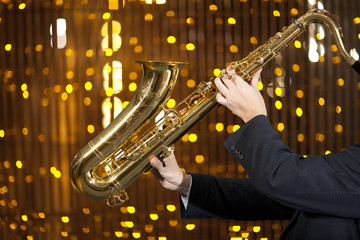 Fototapeta na wymiar Saxophonist. Man playing on saxophone